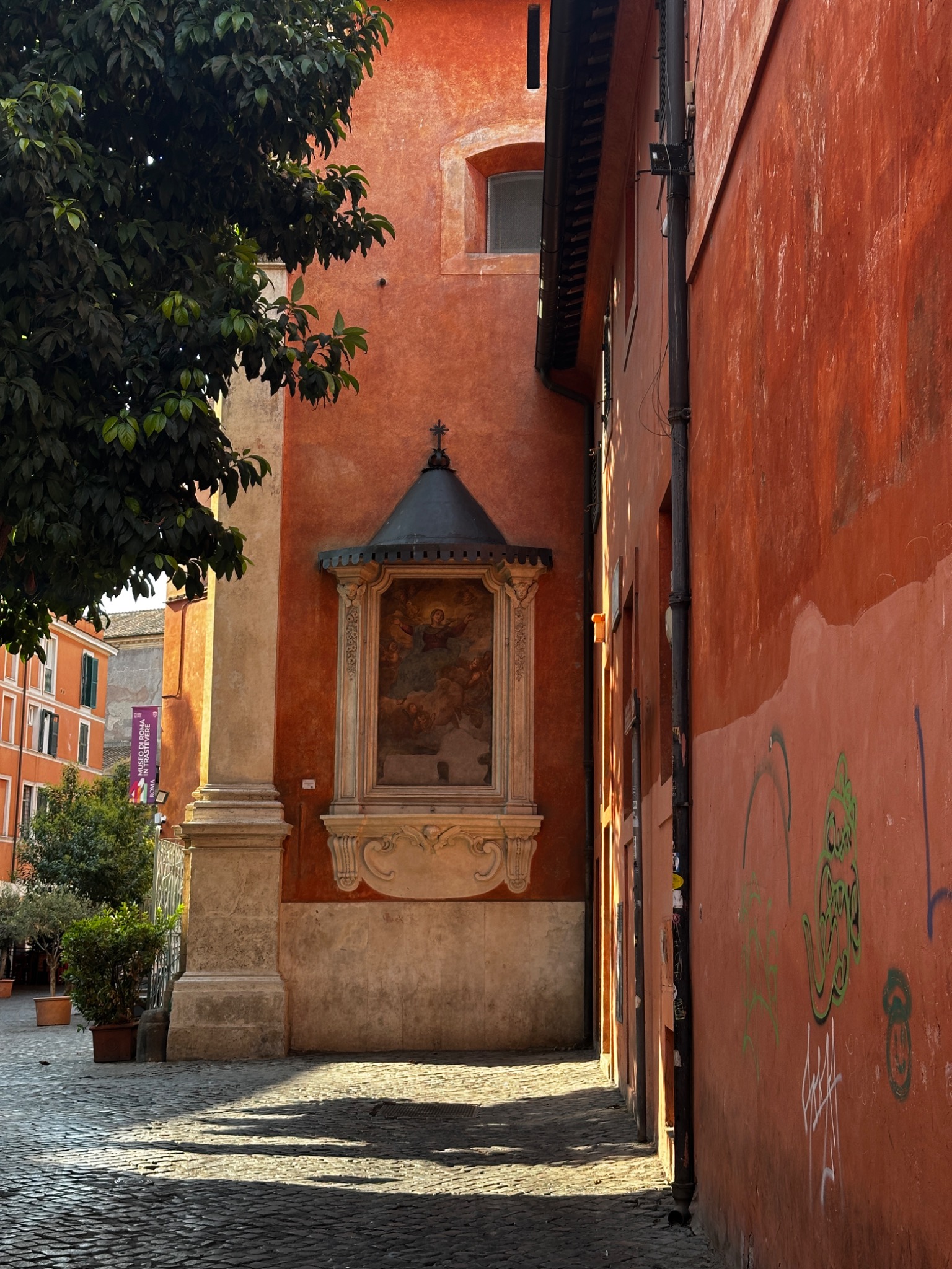 A richly colored Roman passage with historic architecture and greenery